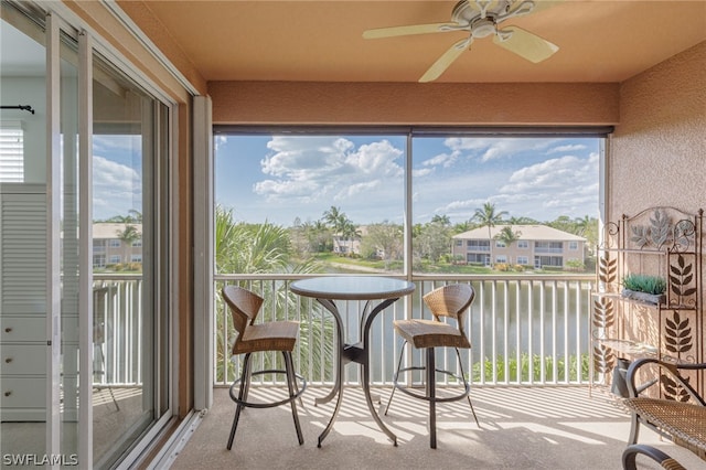 sunroom featuring a healthy amount of sunlight and ceiling fan