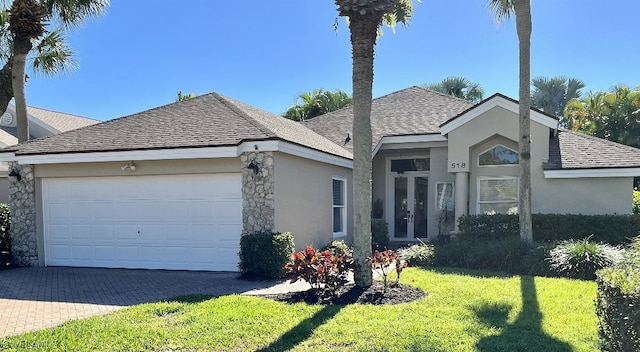 ranch-style home featuring a garage and a front lawn