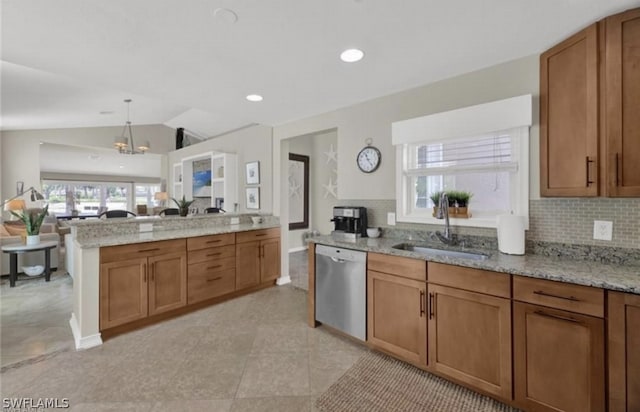 kitchen with dishwasher, sink, light tile flooring, and light stone counters