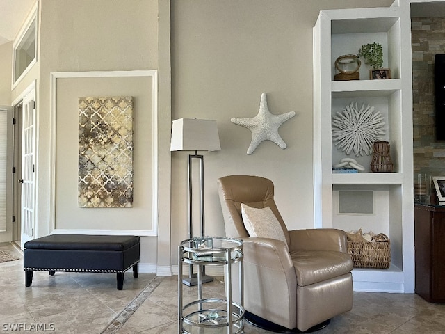 sitting room with tile flooring and built in features