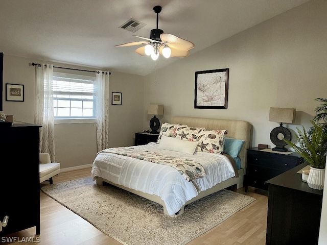 bedroom with light hardwood / wood-style floors, ceiling fan, and vaulted ceiling