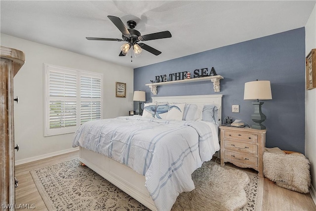 bedroom with light hardwood / wood-style flooring and ceiling fan