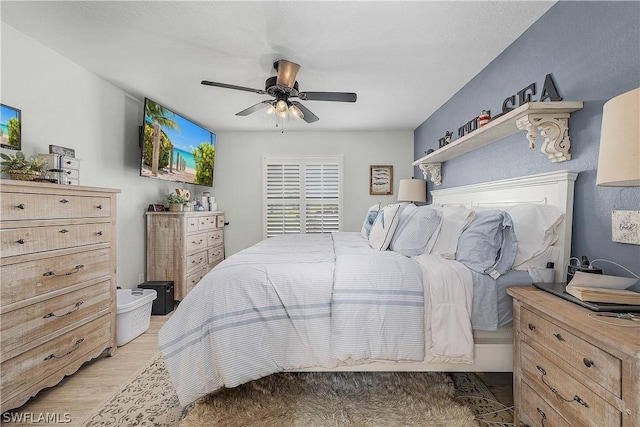 bedroom with ceiling fan and light wood-type flooring