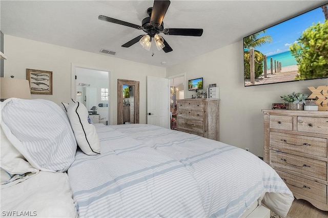 bedroom with ensuite bathroom and ceiling fan