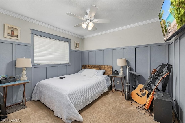 bedroom featuring ceiling fan, crown molding, and light colored carpet