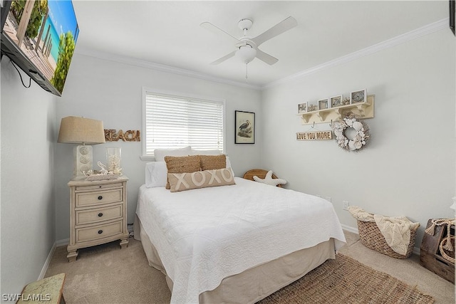 carpeted bedroom featuring ceiling fan and crown molding