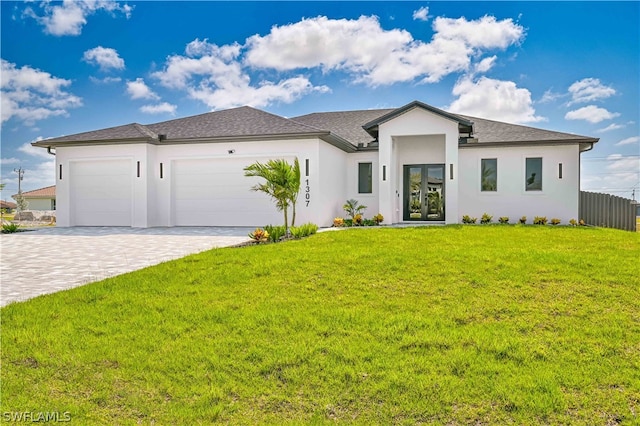 view of front of home with a garage and a front lawn