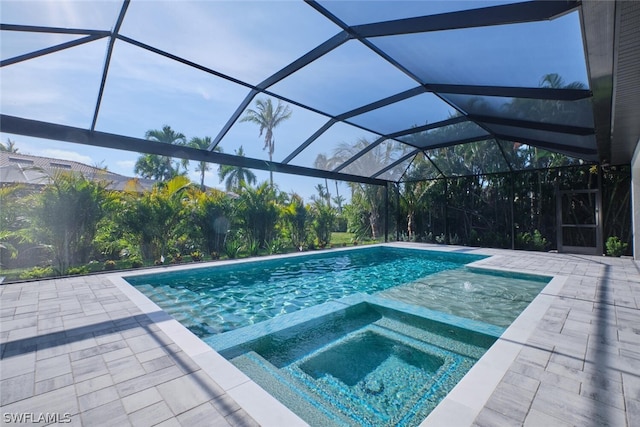 view of pool with glass enclosure, an in ground hot tub, and a patio area