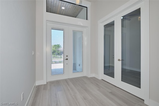 doorway with light hardwood / wood-style floors, french doors, and wooden ceiling