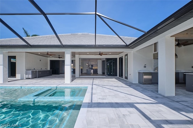 view of swimming pool featuring ceiling fan, a lanai, and a patio