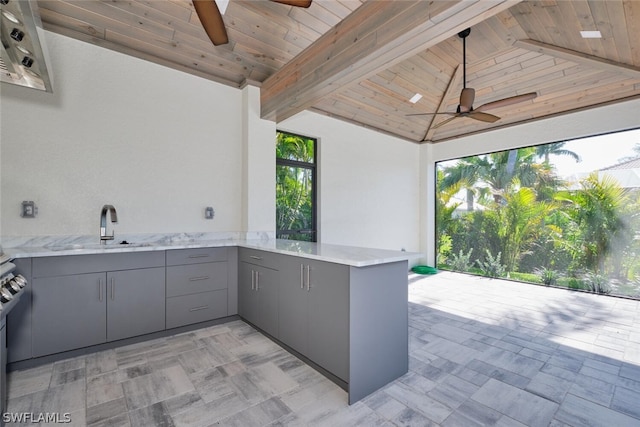 interior space with sink and ceiling fan