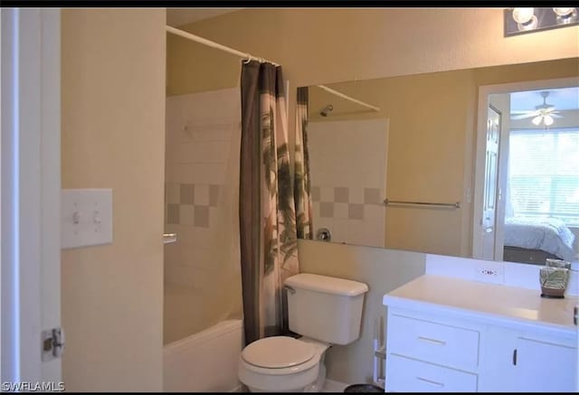 full bathroom featuring shower / bath combo, oversized vanity, toilet, and ceiling fan