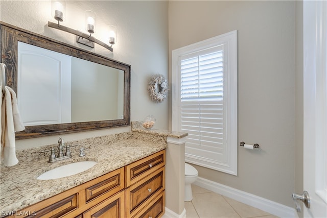 bathroom featuring tile floors, large vanity, and toilet