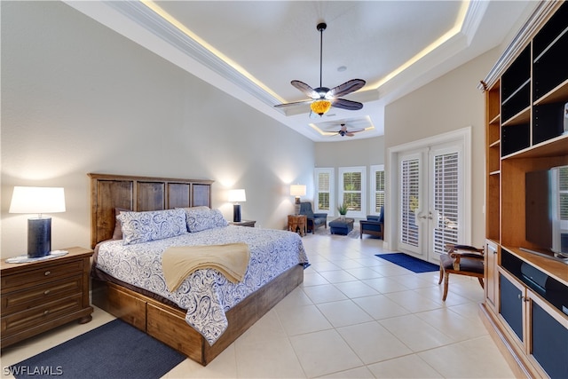 bedroom with french doors, a tray ceiling, access to exterior, ceiling fan, and light tile floors