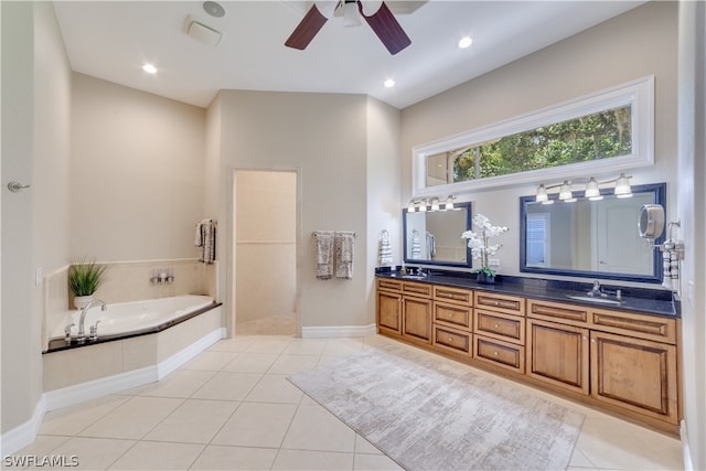 bathroom with tile floors, dual bowl vanity, a washtub, and ceiling fan