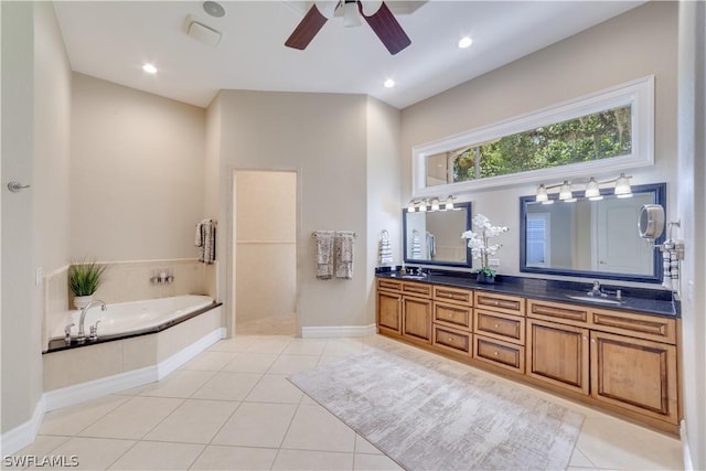 bathroom featuring tile patterned flooring, a garden tub, a sink, baseboards, and double vanity