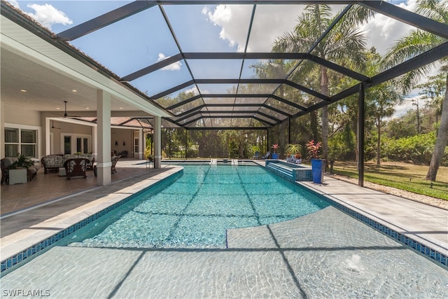 view of swimming pool featuring a lanai and a patio area