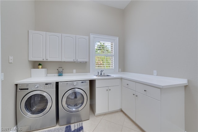 laundry room featuring independent washer and dryer, sink, light tile floors, and cabinets