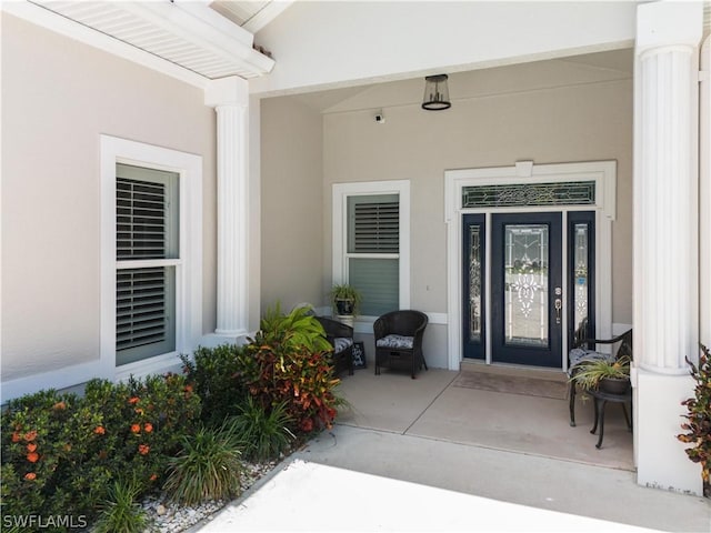 property entrance with stucco siding