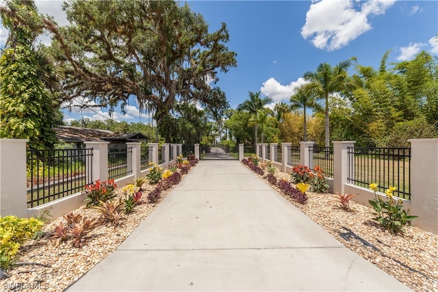 view of community with a fenced front yard