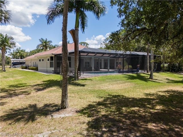 back of house featuring a yard and a lanai