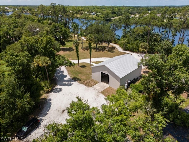 aerial view featuring a water view and a wooded view