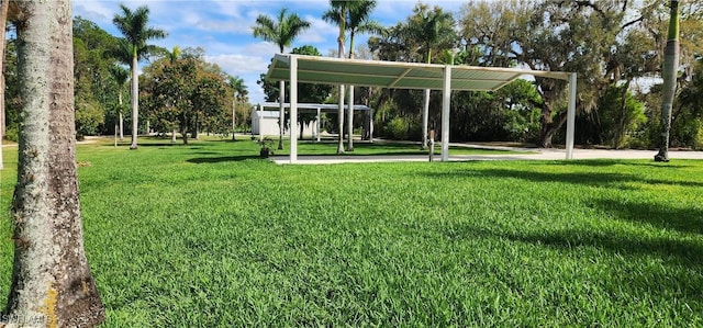 surrounding community with a carport and a lawn