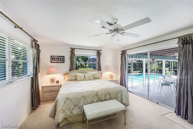 bedroom with access to outside, multiple windows, ceiling fan, and light carpet