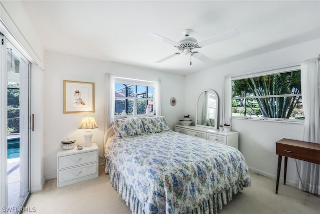 carpeted bedroom with ceiling fan and access to exterior