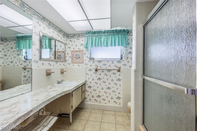 bathroom featuring tile patterned floors, vanity, toilet, and an enclosed shower