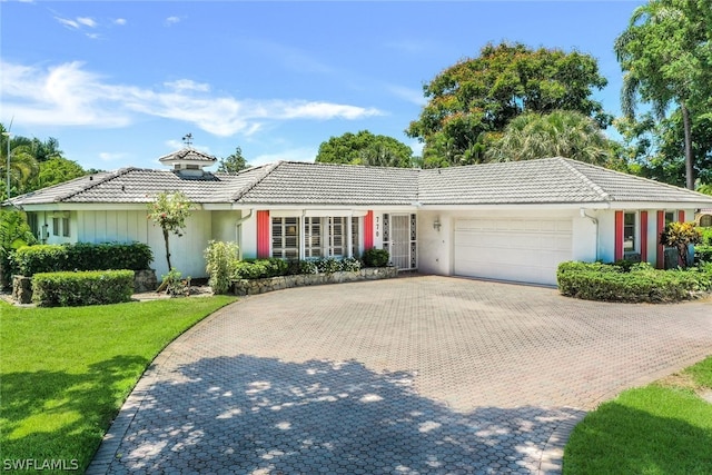 ranch-style home with a front yard and a garage