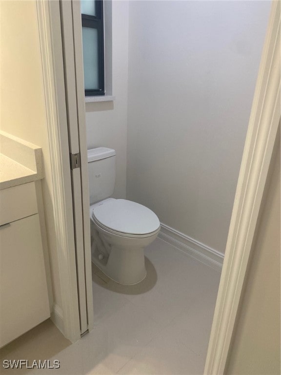 bathroom with tile patterned floors, vanity, and toilet