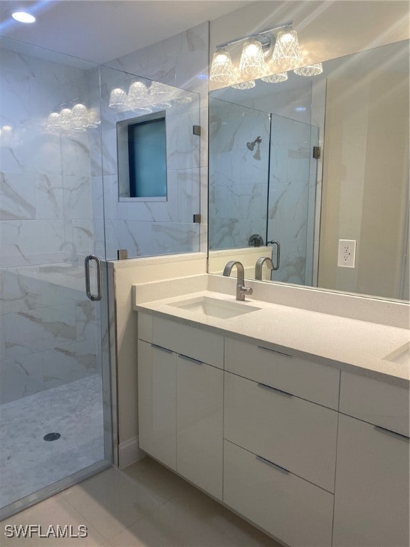 bathroom featuring tile patterned flooring, vanity, and an enclosed shower