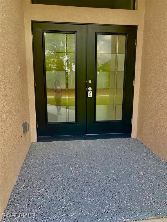 entrance to property featuring french doors