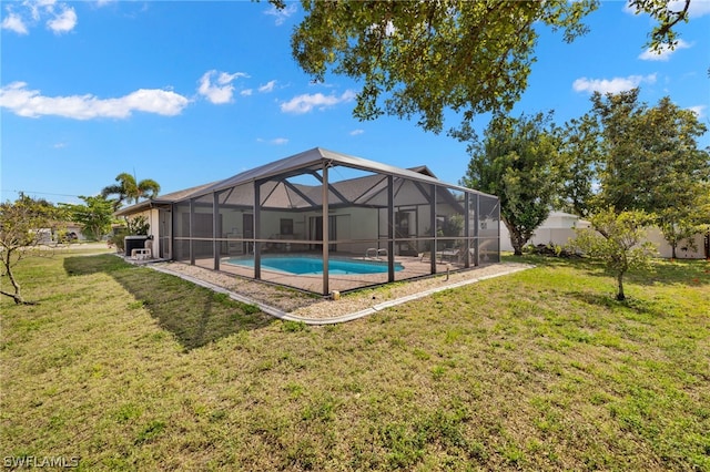 view of swimming pool featuring a lanai and a yard