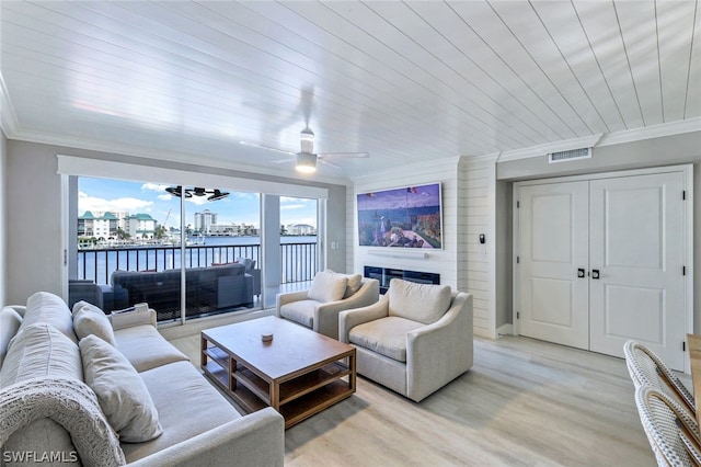 living room with ceiling fan, light hardwood / wood-style floors, crown molding, a water view, and wooden ceiling