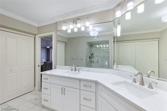 bathroom with a shower with shower door, dual bowl vanity, tile floors, and crown molding