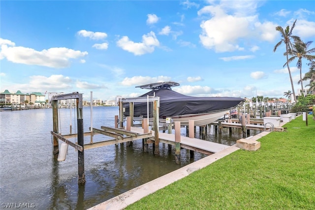 view of dock featuring a lawn and a water view