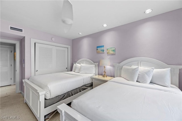 carpeted bedroom featuring a closet