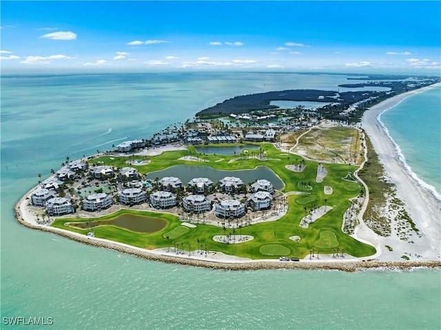 birds eye view of property with a water view and a beach view