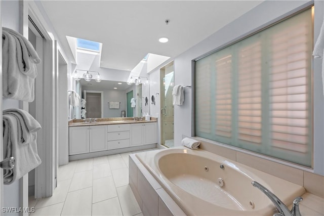 bathroom with vanity, a skylight, tile patterned floors, and shower with separate bathtub