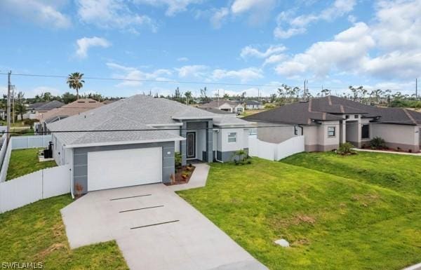 ranch-style home featuring concrete driveway, a residential view, an attached garage, fence, and a front lawn