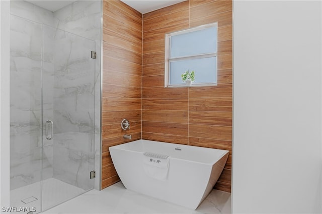 bathroom featuring tile walls, tile patterned floors, and shower with separate bathtub