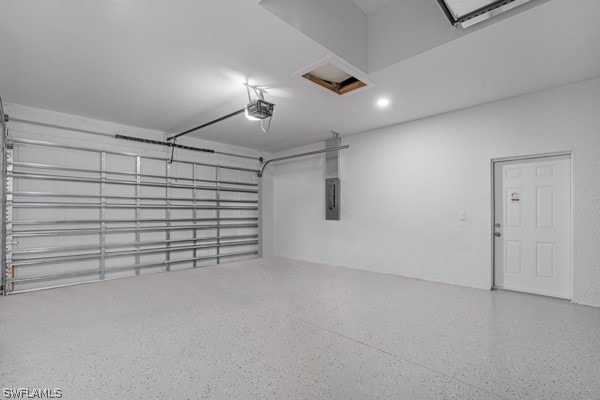 garage with a garage door opener and electric panel