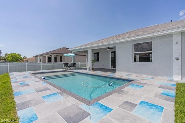 view of pool featuring a patio area, ceiling fan, fence, and a fenced in pool