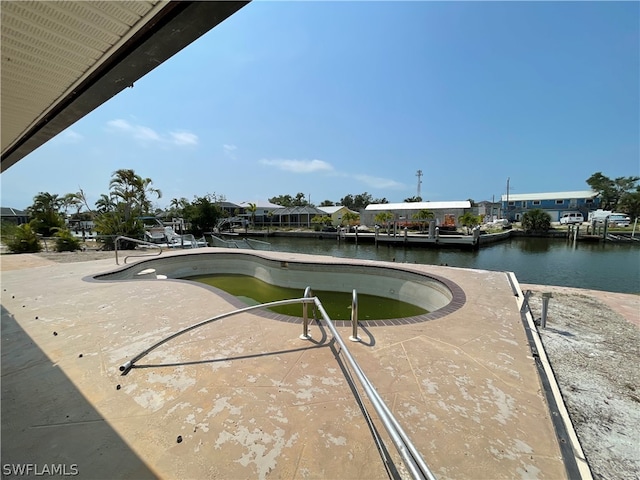 view of pool featuring a boat dock and a water view