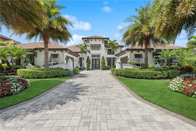 mediterranean / spanish-style home with a front yard