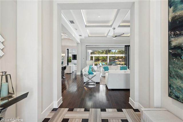 corridor with coffered ceiling, dark hardwood / wood-style flooring, and beamed ceiling