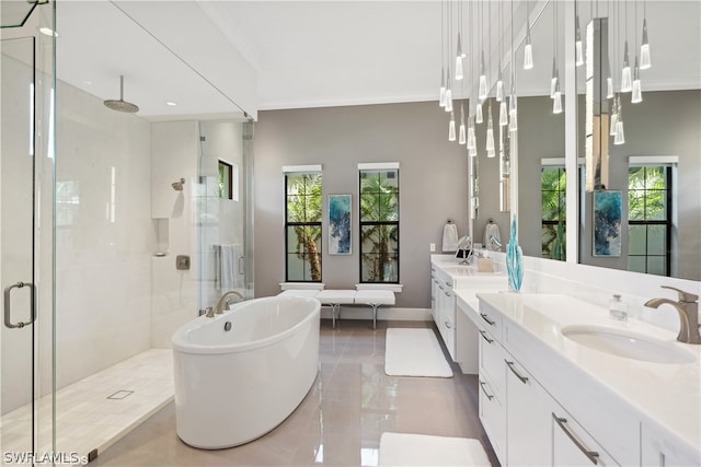 bathroom featuring ornamental molding, vanity, and shower with separate bathtub