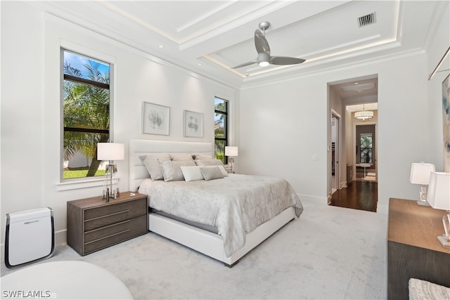 bedroom featuring crown molding, light colored carpet, and ceiling fan